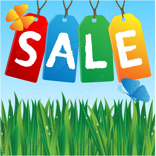 colored labels sales against the blue sky and green grass