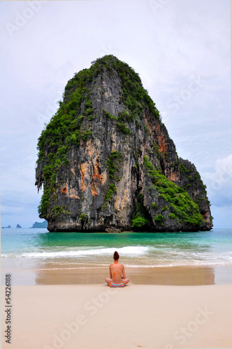 woman alone sit on the beach looking sea and island. © CasanoWa Stutio