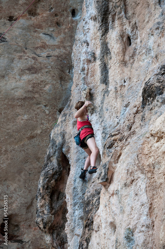 Woman climbing on the rock route summer (Railay Beach, Krabi pro