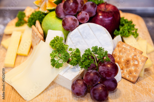 Various types of cheese and ripe grapes buffet.