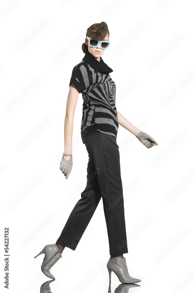 fashion model in fashion dress wearing sunglasses walking fashion model in fashion dress wearing sunglasses walking