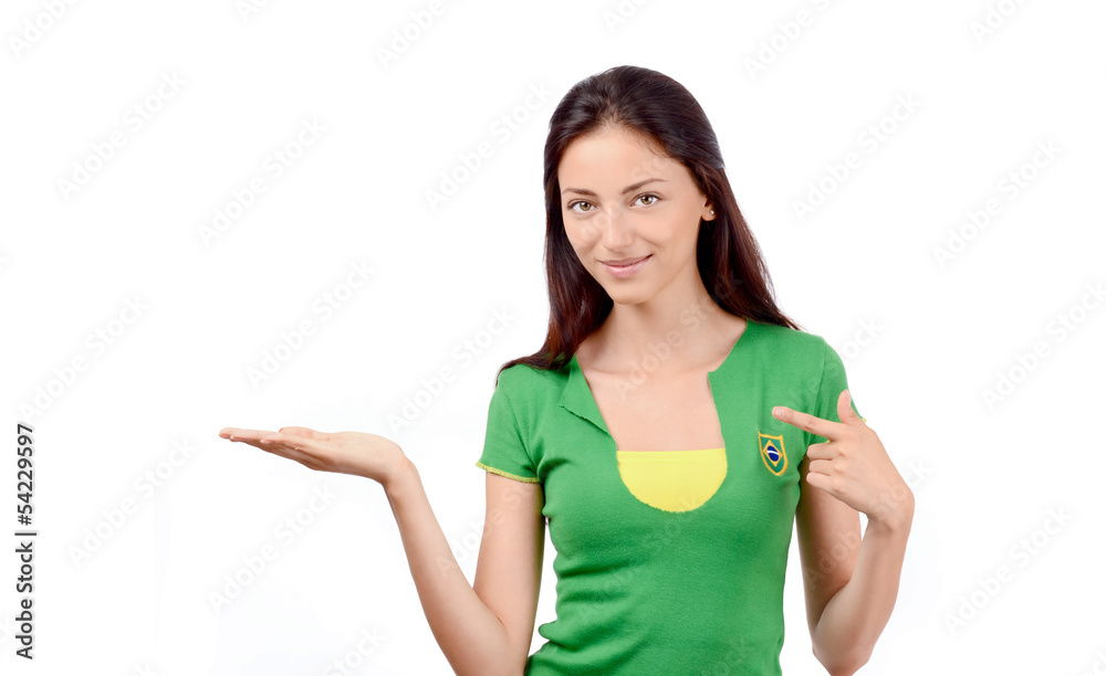 Girl with Brazilian flag on her shirt pointing and showing. Girl with Brazilian flag on her shirt pointing and showing.