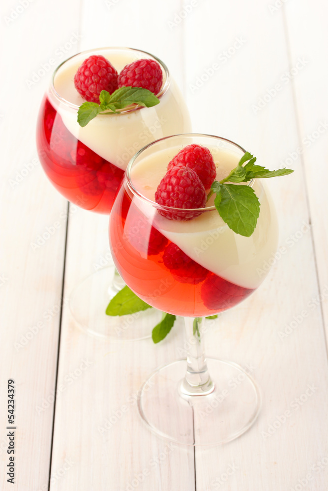 fruit jelly with raspberries in glasses on wooden table fruit jelly with raspberries in glasses on wooden table