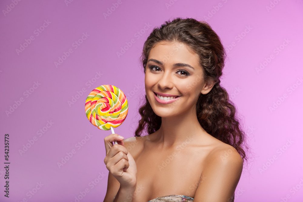 Beauty with lollipop. Beautiful young women holding a lollipop w