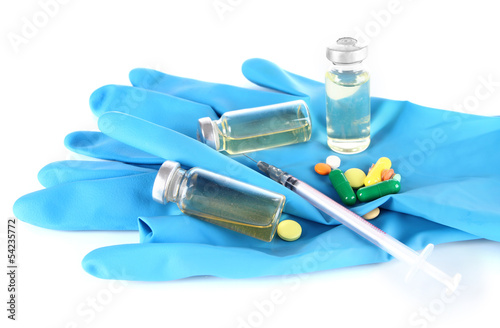 Medical bottles gloves and syringe isolated on white