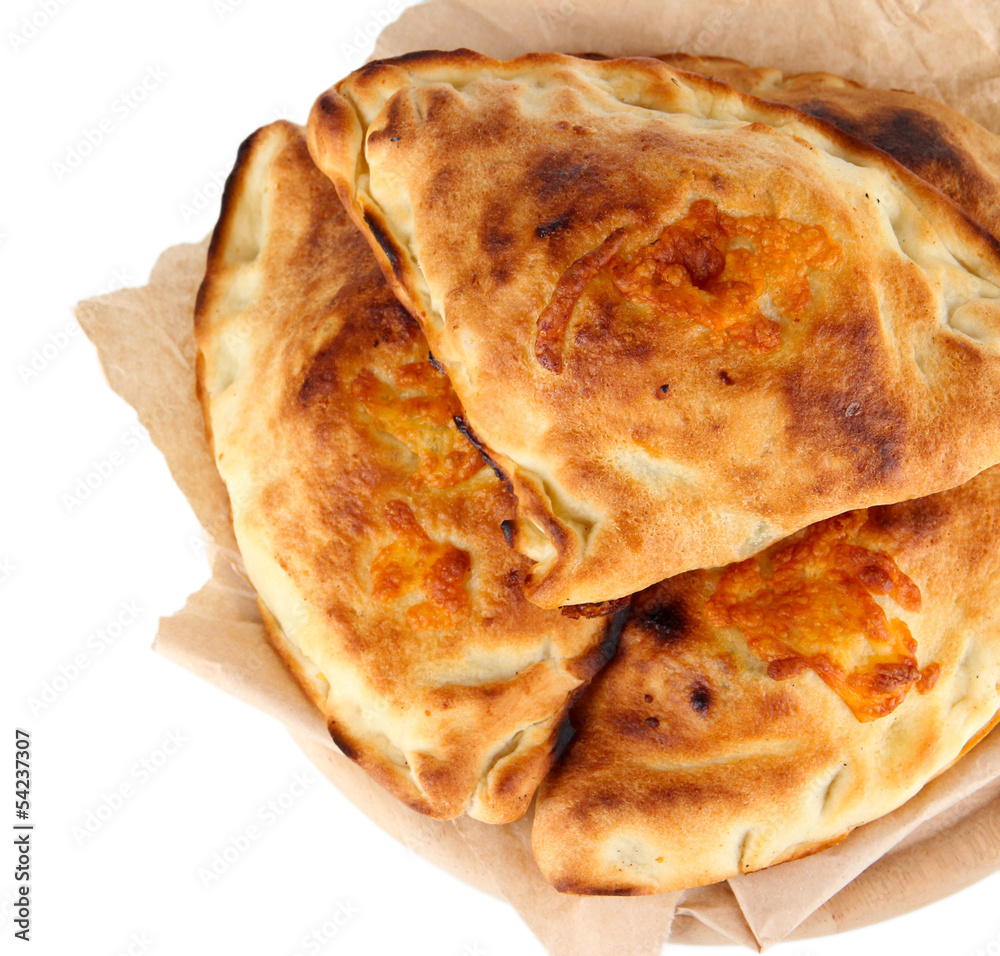 Pizza calzones on tracing paper isolated on white Pizza calzones on tracing paper isolated on white