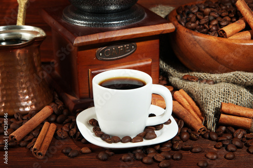 Coffee cup and metal turk on wooden background