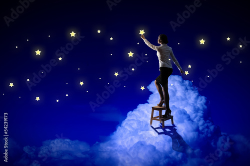 Woman lighting stars © Sergey Nivens