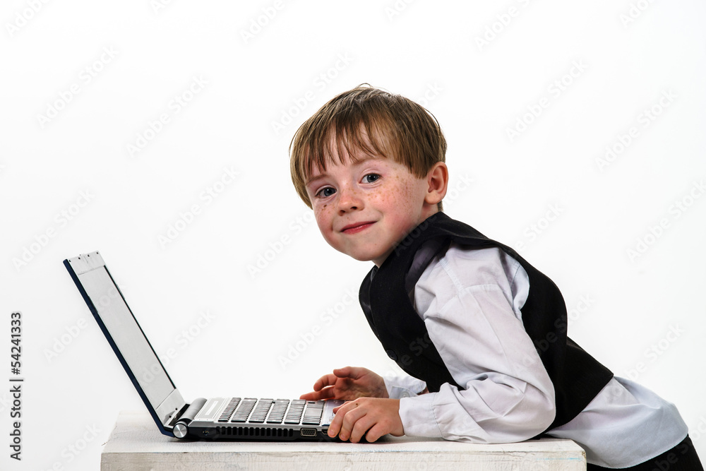 Freckled red-hair little boy with laptop. Freckled red-hair little boy with laptop.