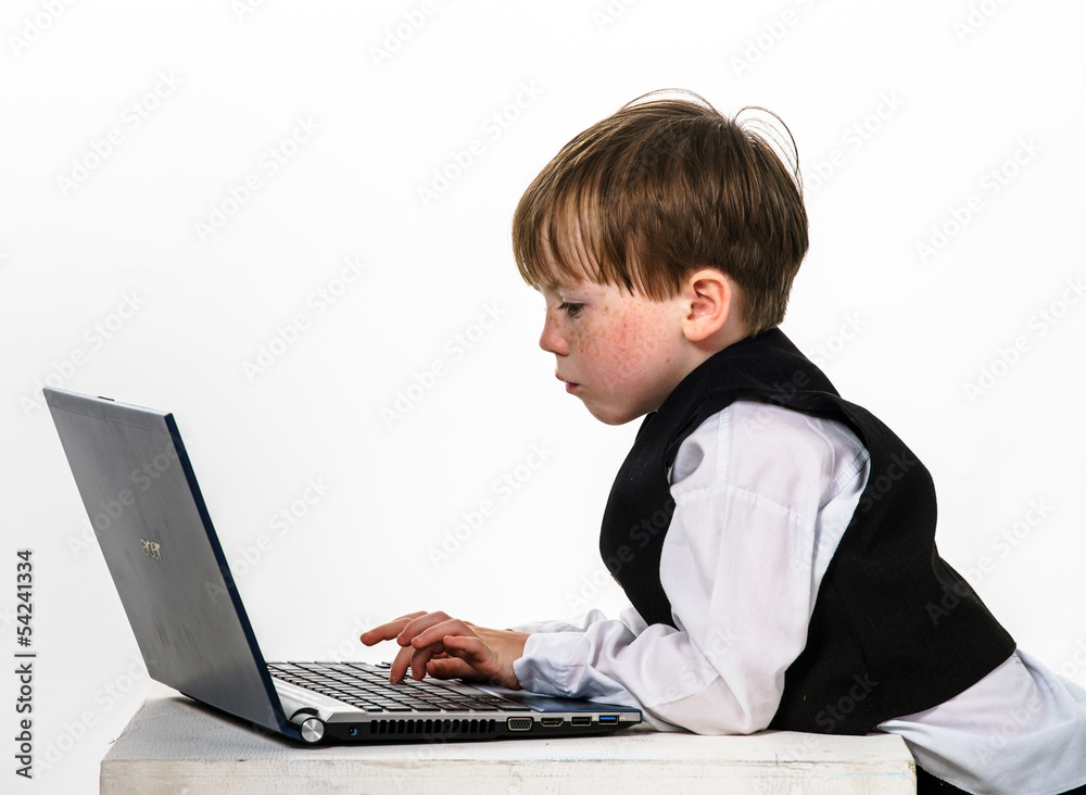 Freckled red-hair little boy with laptop. Freckled red-hair little boy with laptop.