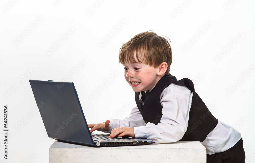 Freckled red-hair little boy with laptop. Freckled red-hair little boy with laptop.