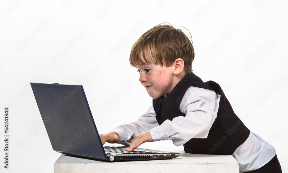 Freckled red-hair little boy with laptop. Freckled red-hair little boy with laptop.