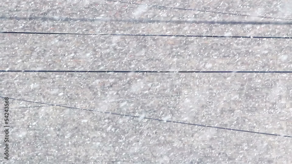 Snowfall. In the picture there are electric wires Snowfall. In the picture there are electric wires