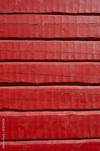 Red painted, hand carved log wall, texture material.