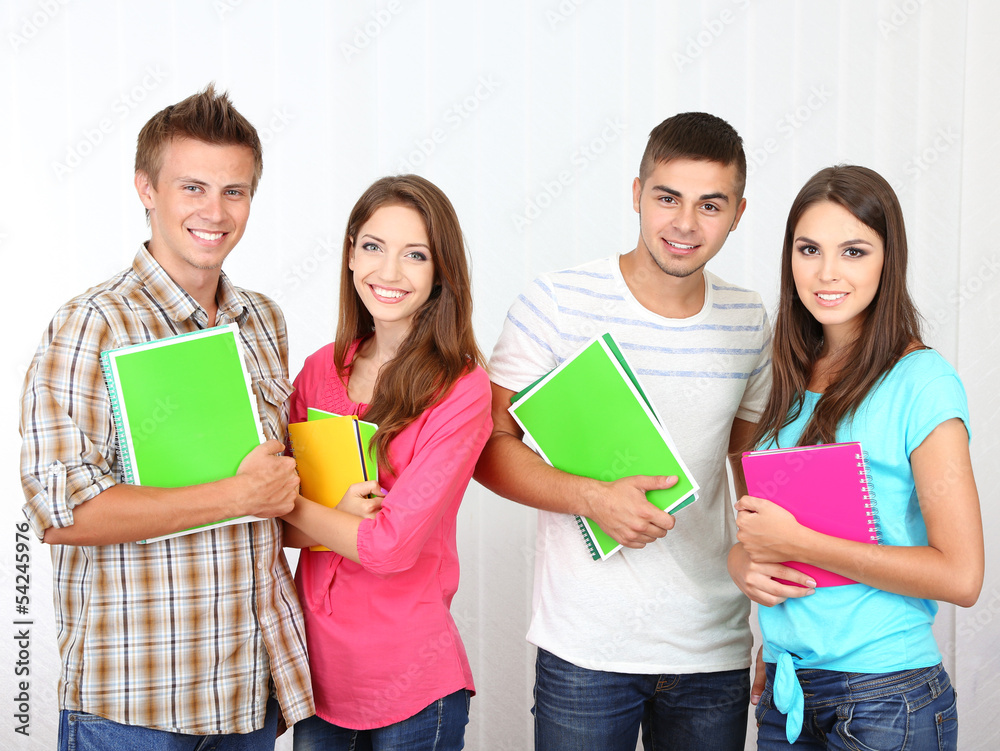 Group of happy beautiful young students at room Group of happy beautiful young students at room