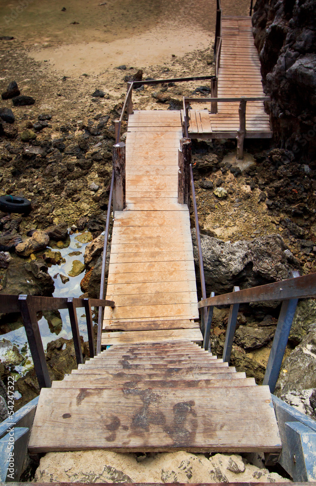 Fototapeta premium Wooden stairs to the rock beach