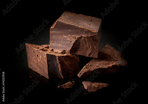 Chopped chocolate on a black background photo