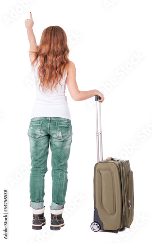 Back view of pointing woman with suitcase looking up