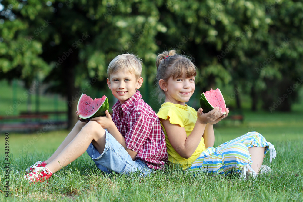 boy and little girl eat watermelon boy and little girl eat watermelon