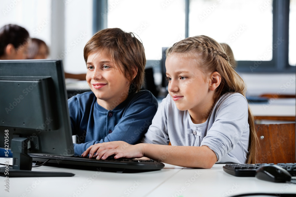 Boy And Girl Using Desktop Pc In School Computer Lab Boy And Girl Using Desktop Pc In School Computer Lab