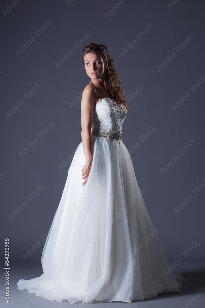 Beautiful model posing in elegant wedding dress Beautiful model posing in elegant wedding dress