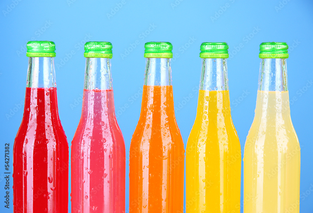 Bottles with tasty drinks on bright background Bottles with tasty drinks on bright background