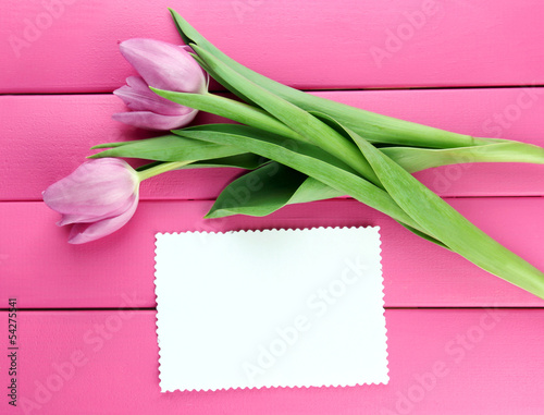 Beautiful bouquet of purple tulips and blank card