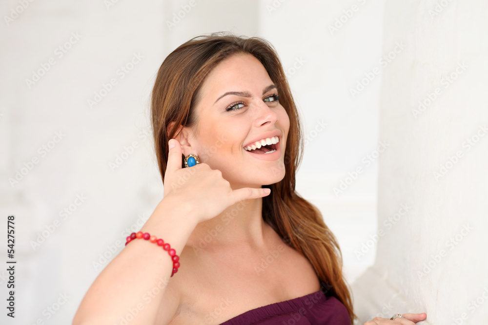 Woman making a call me sign outdoors Woman making a call me sign outdoors