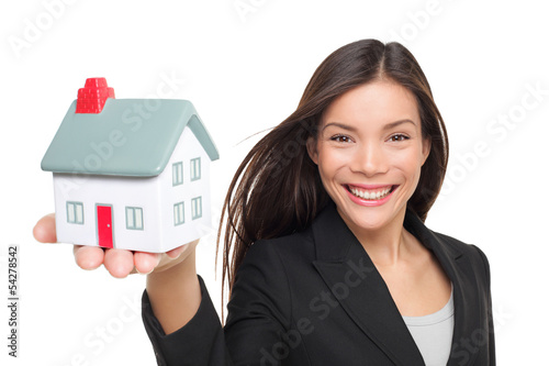 Real estate agent selling home holding mini house