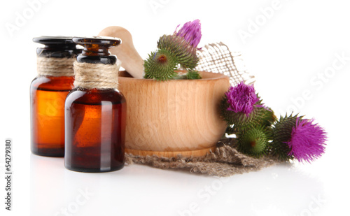 Medicine bottles and mortar with thistle flowers, isolated