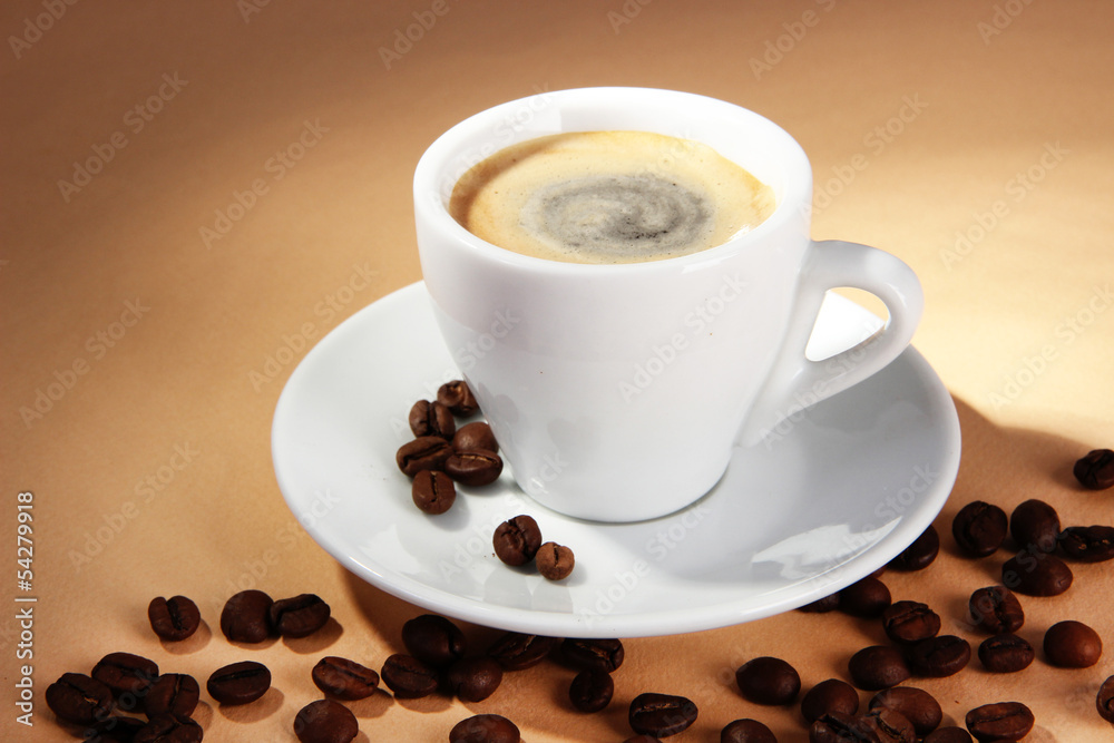Cup of coffee with coffee beans on beige background Cup of coffee with coffee beans on beige background
