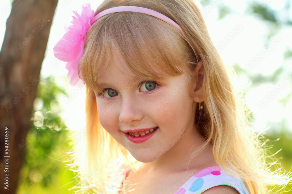 Fototapeta premium Portrait of pretty little girl outdoors