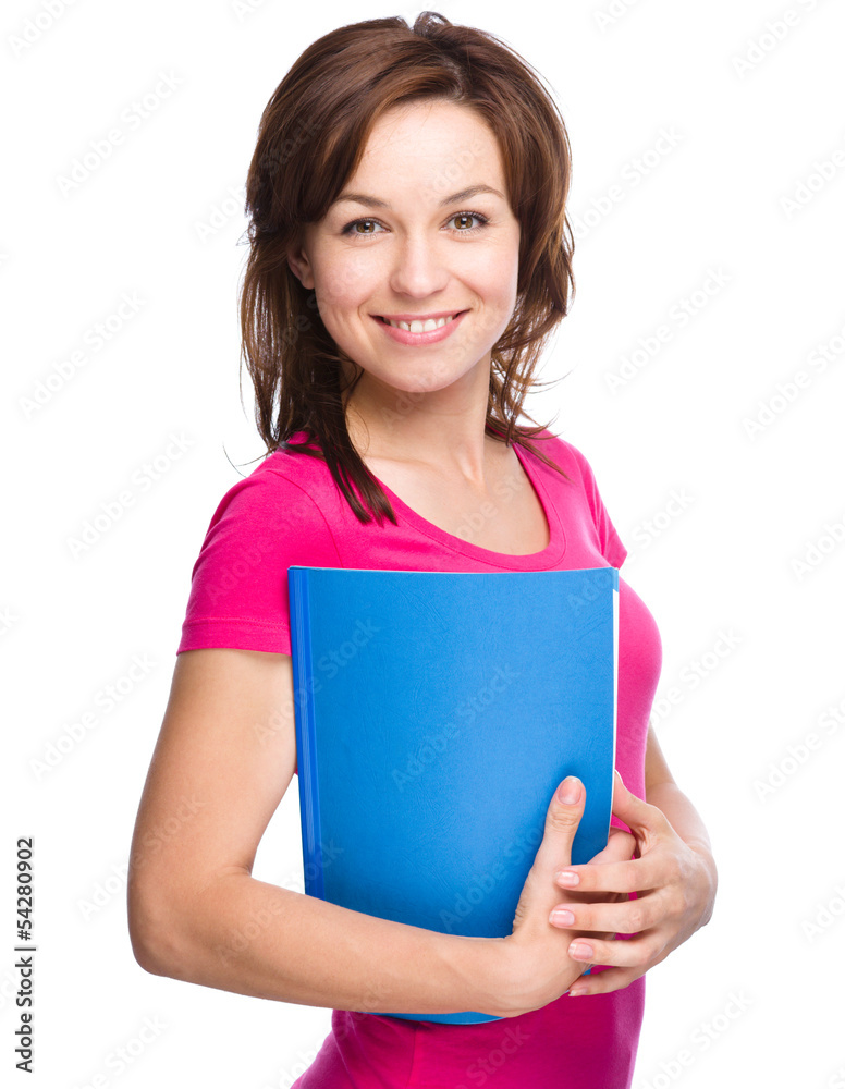 Young skinny student girl is holding exercise book Young skinny student girl is holding exercise book