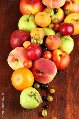 Assortment of juicy fruits  on wooden background