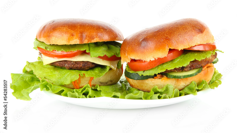 Big and tasty hamburgers on plate isolated on white Big and tasty hamburgers on plate isolated on white