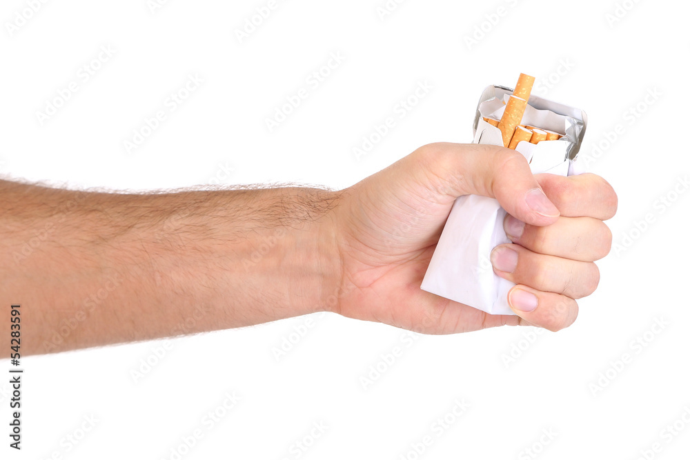 Fist with crushed pack of cigarettes, isolated on white