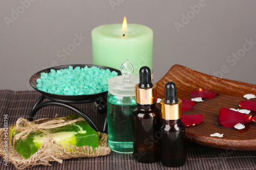 Spa composition with aroma oils on table on gray background