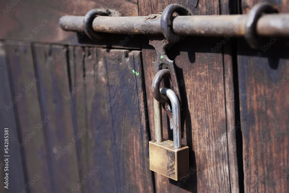 Padlock, close up wood door with metal locked Padlock, close up wood door with metal locked