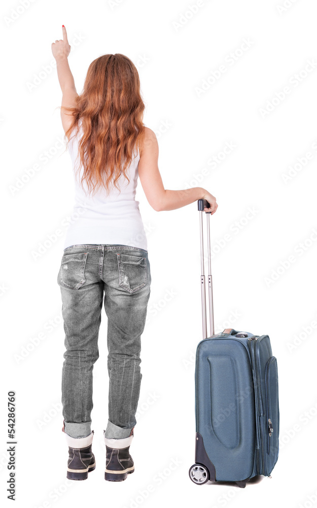 Back view of pointing woman with suitcase looking up Back view of pointing woman with suitcase looking up