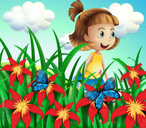 A small girl at the flower garden with butterflies