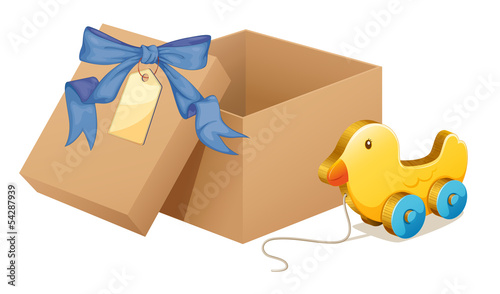 A wooden duck beside a brown box
