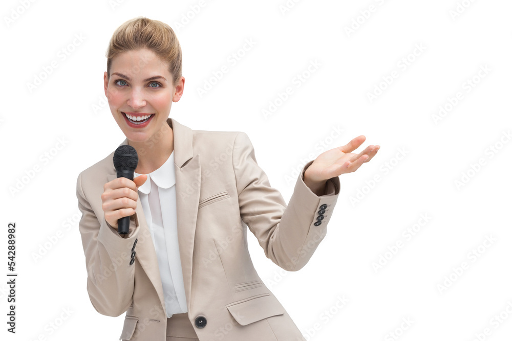 Gesturing businesswoman speaking on microphone Gesturing businesswoman speaking on microphone