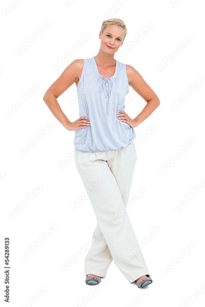 Woman smiling at camera with hands on hips Woman smiling at camera with hands on hips