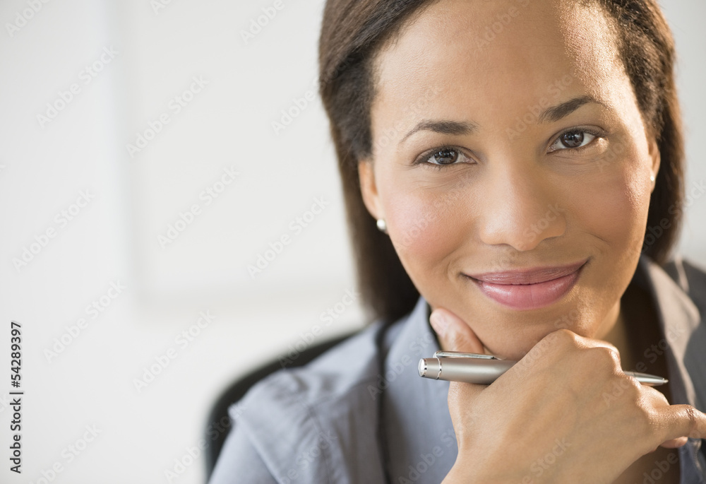 Confident Businesswoman Smiling With Hand On Chin Confident Businesswoman Smiling With Hand On Chin