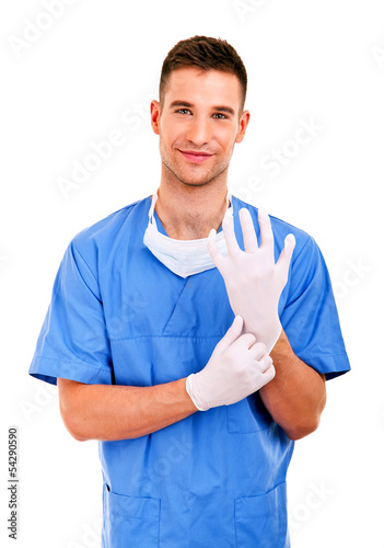 Young doctor with mask and blue uniform over white background