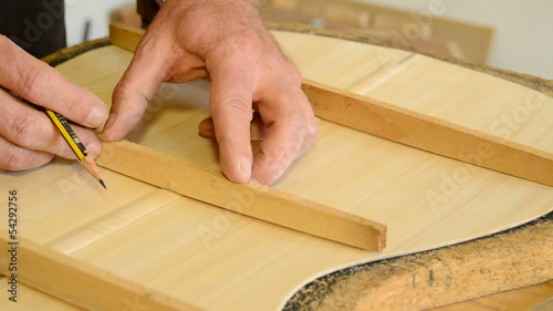 Luthier manufacturing a clasical guitar, close up photo