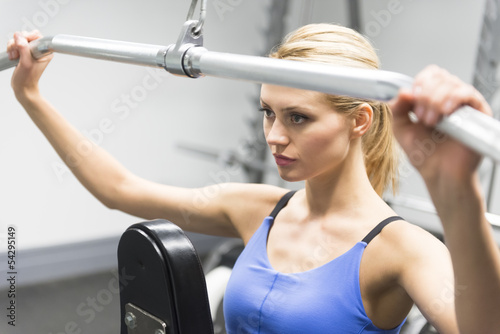 Woman Exercising With Pulley In Gym