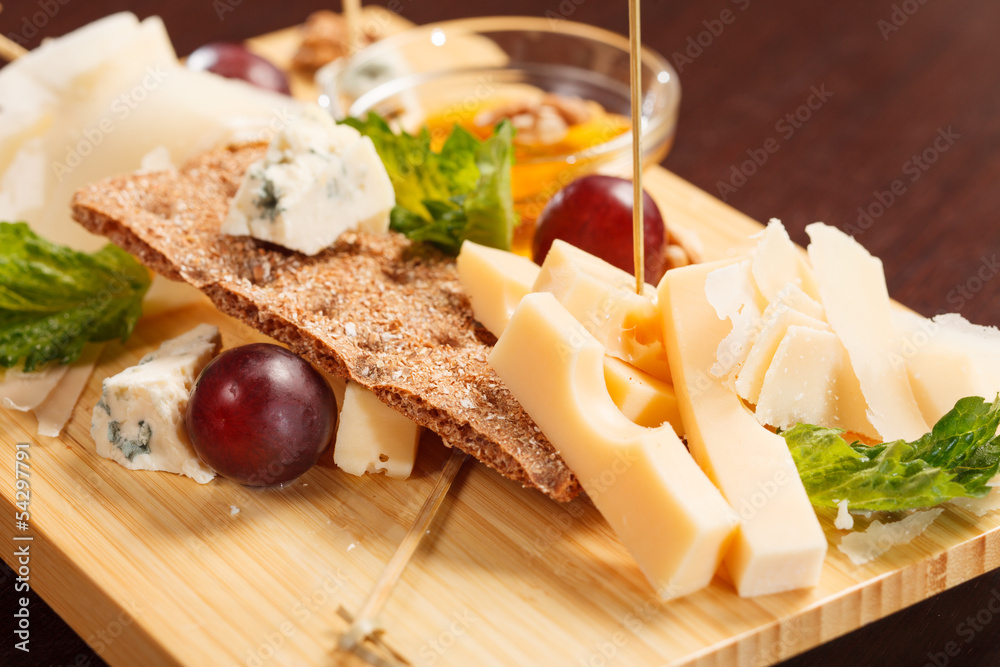 Cheese plate with grapes and honey