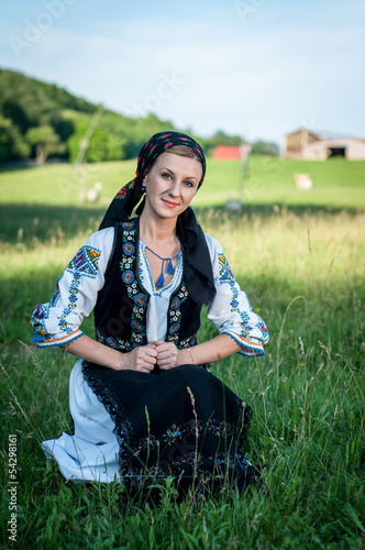Young beautiful singer posing in traditional costume, romanian f