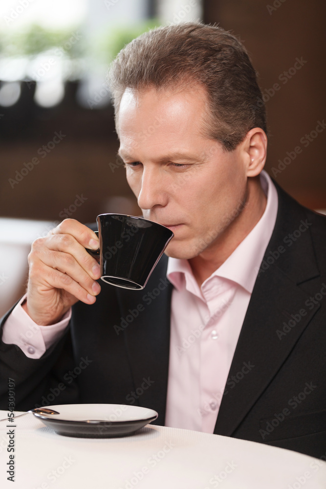 Businessmen at coffee break. Thoughtful mature men in formalwear Businessmen at coffee break. Thoughtful mature men in formalwear